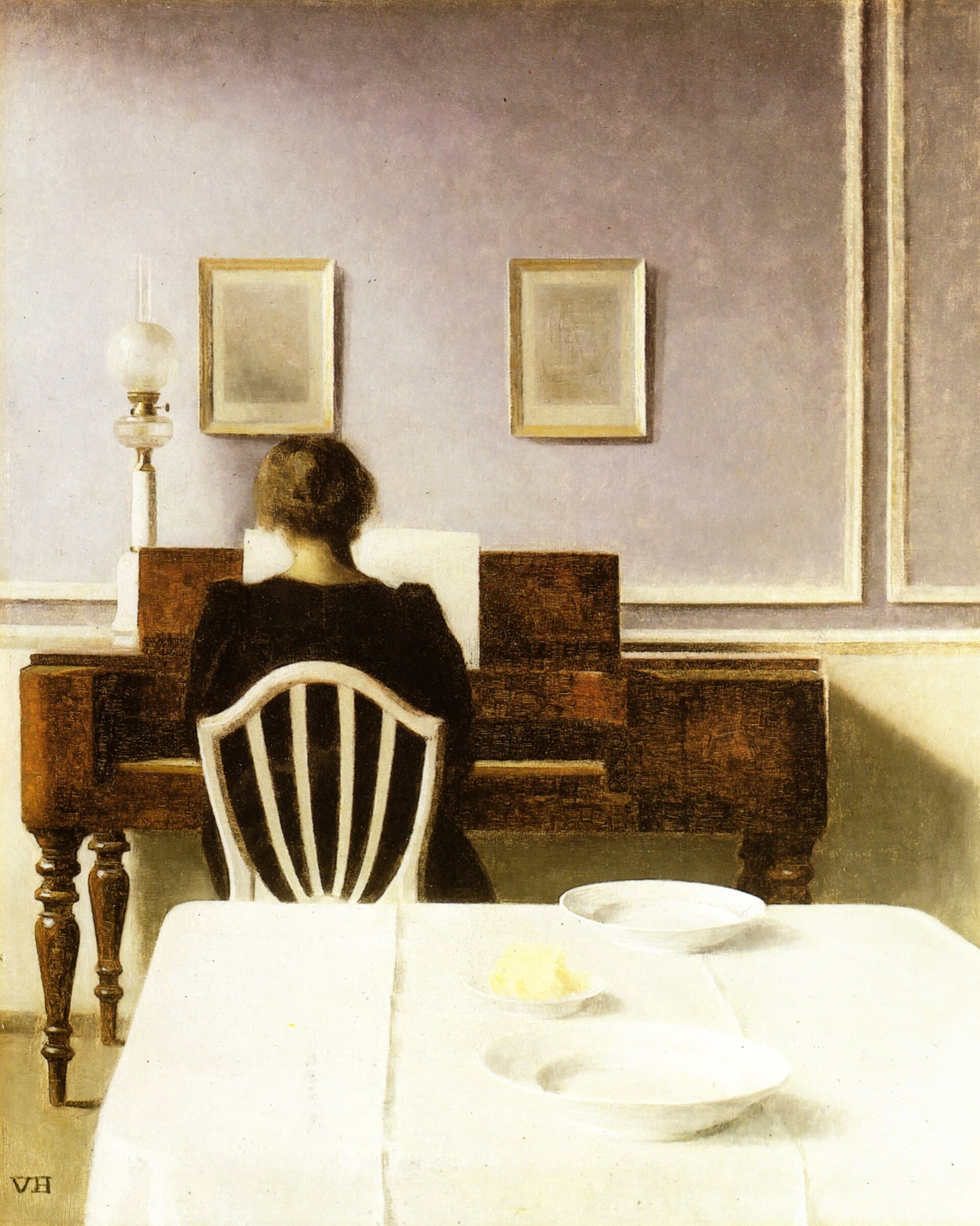 A pale panelled room, a figure seated at a keyboard against the far wall