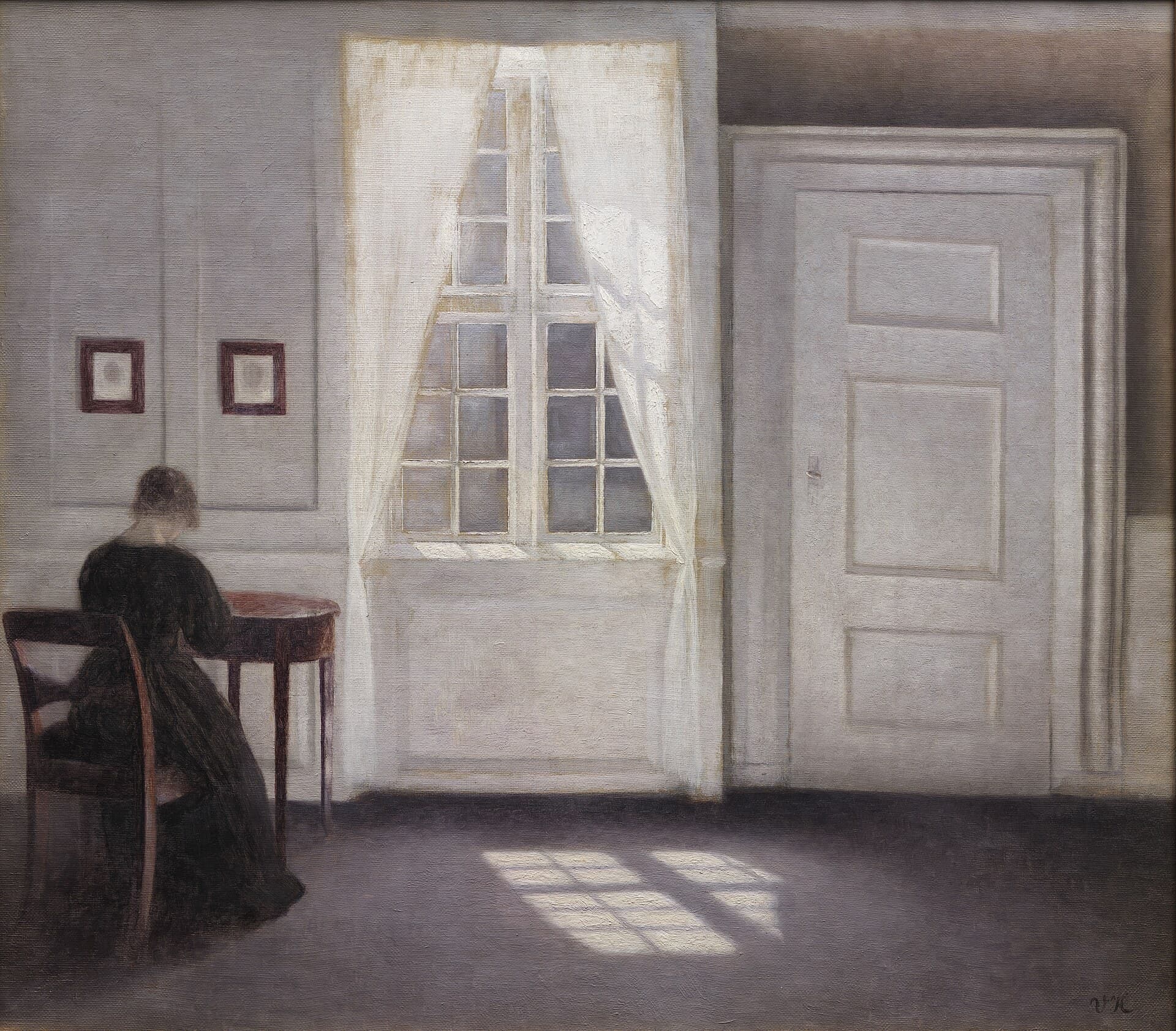 A quiet interior with sunlight falling across the floorboards beside a tall window