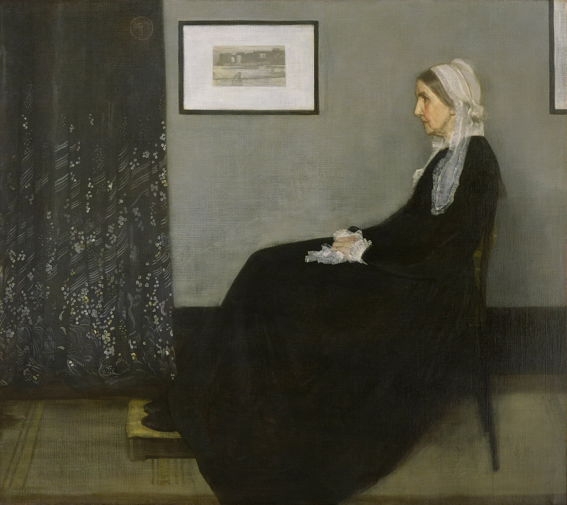 A seated figure in profile against a grey wall, almost entirely in silhouette